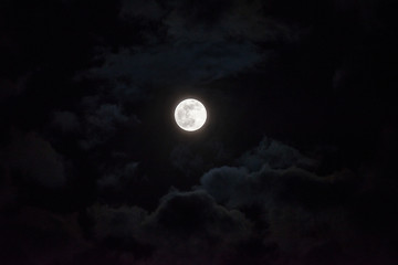 Moon through the clouds at night, super moon