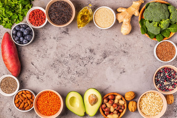 Superfoods on gray concrete background. Top view.