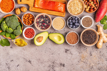 Superfoods on gray concrete background. Top view.