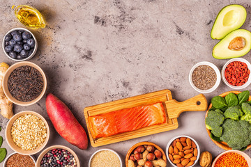 Superfoods on gray concrete background. Top view.