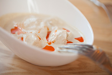 Chicken fillet in a cream sauce in a white dish