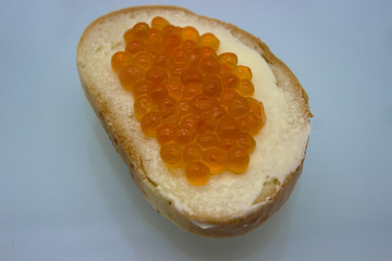 Red caviar on sandwiches on the white background