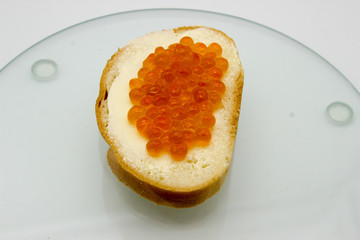 Red caviar on sandwiches on the white background