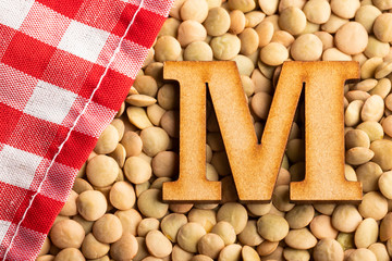 Letter M, Lentils with checkered napkin - Top view