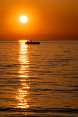 Silhouette of big buoy from sunset sunshine in Trieste, Italy