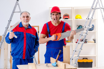 Two professional contractors laying flooring at home  