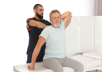 Fototapeta na wymiar Physiotherapist working with patient in clinic. Rehabilitation therapy