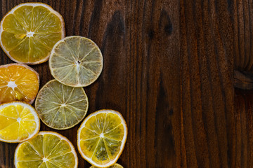 Fototapeta na wymiar sliced dried lemons and limes on a wooden Board
