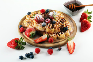 Waffle. Traditional belgian waffles with fresh fruit and powder sugar on wood