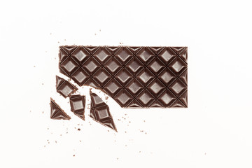 Cracked chocolate bar with Chia seeds on white background