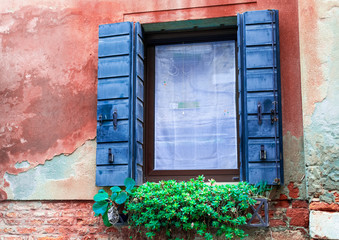Venice / Italy 19 february 2019 :traditional window with flowers in venice street
