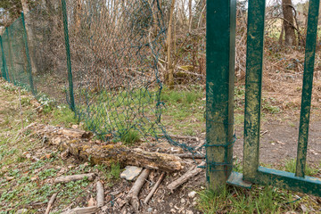 Security breach into wire mesh fence through big hole