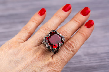 A ring with ruby quartz on a hand