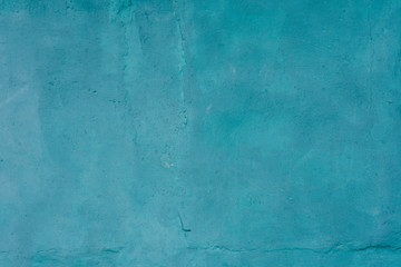 Fototapeta na wymiar Background of old cracked plaster painted in blue