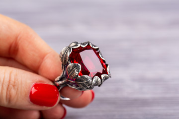A stone from ruby quartz with a facet in a ring