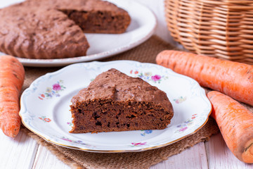 Chocolate cake with carrots in a bowl on a wooden table