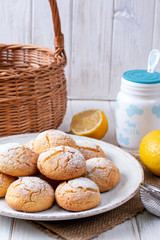 Plate with homemade lemon cookies on wooden table