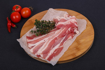 Raw bacon on the board