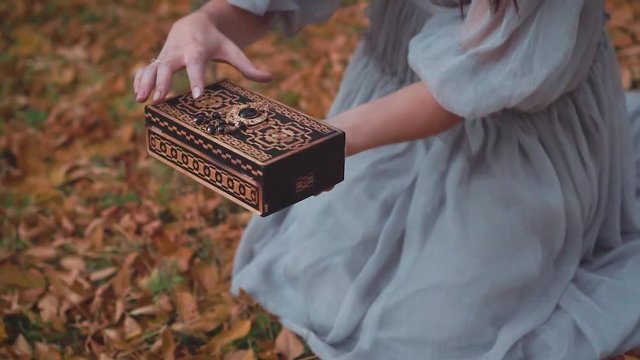 terrible act of unwary woman, Pandora opens the forbidden box and makes mistake, punishment of Pandora by gods, girl with dark hair produces green smoke from wooden box, Greek mythology and legends