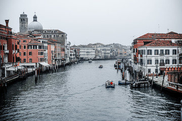 Venice / Italy 19 february 2019 :Snapshot of the  canal and the buildings around it,also boats and other transport,photo taken from the bridge next to central station of rail