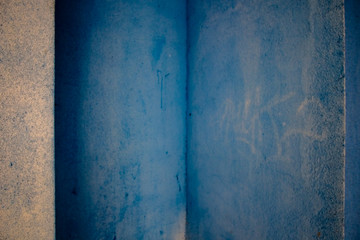 Blue walls full of spots, graphitty letters and other dirt pieces in Pamplona, Spain