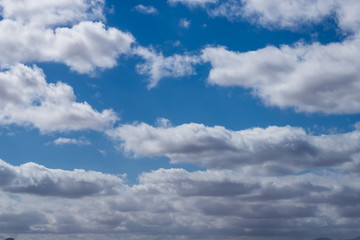 Fototapeta na wymiar cloud formations in the shiny blue sky