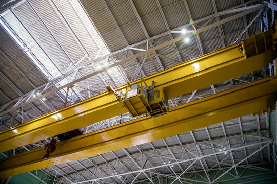 Industrial crane of bridge type inside factory or power plant