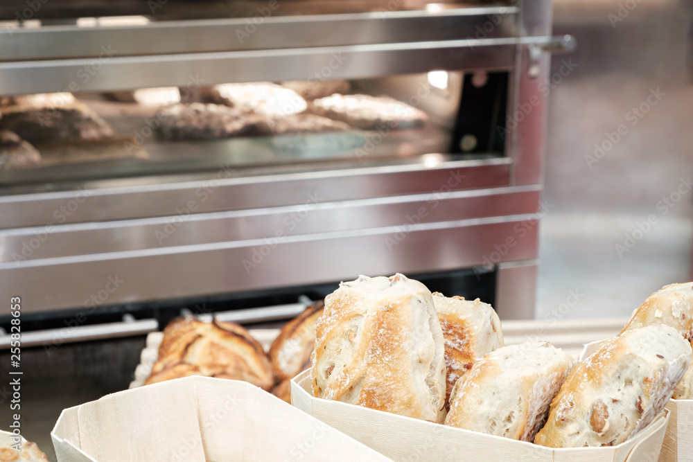Poster wicker basket with bread. bread and buns inside basket. fresh bakery products on table. tastes best 