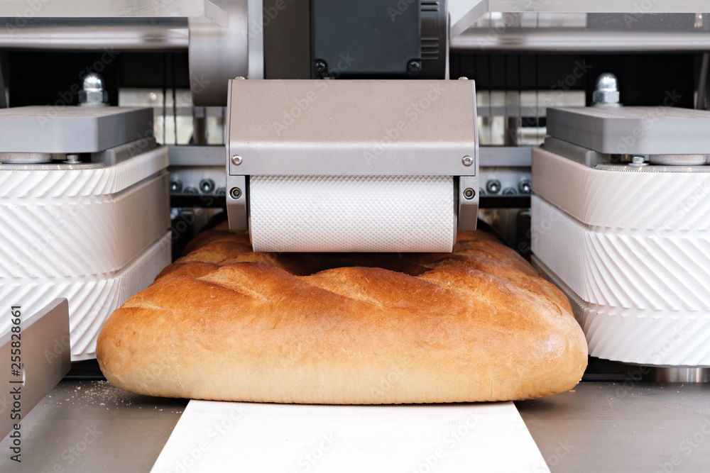 Poster sliced white bread in a cutting machine
