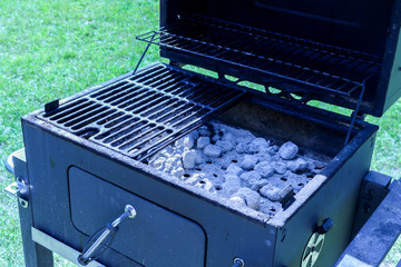 Smoker grill with charcoal in the summer
