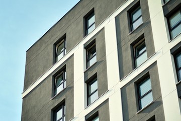 Multistory new modern apartment building. Stylish living block of flats. Modern, new executive apartments and with deep blue summer sky