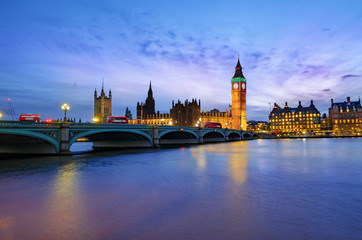 Fototapeta na wymiar London cityscape with Big Ben and City of Westminster Abbey bridge illuminated in evening light, in England