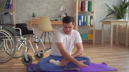 Disabled man doing yoga recovering from injury