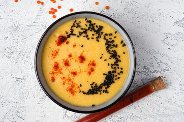 Lentil soup with paprika and sesame seeds. Top view dish