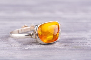 A natural stone of honey color from the Baltic amber in a silver frame