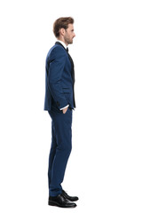 side view of serious man in blue costume looking away