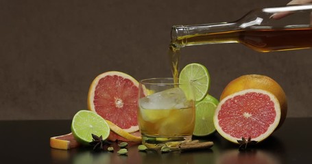 Pour whiskey, cognac, liqueur from a bottle into a glass cup