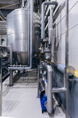 Industrial stainless steel fermentation vats in modern brewery 