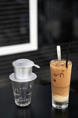 Colorful iced coffee drink on black table outdoors