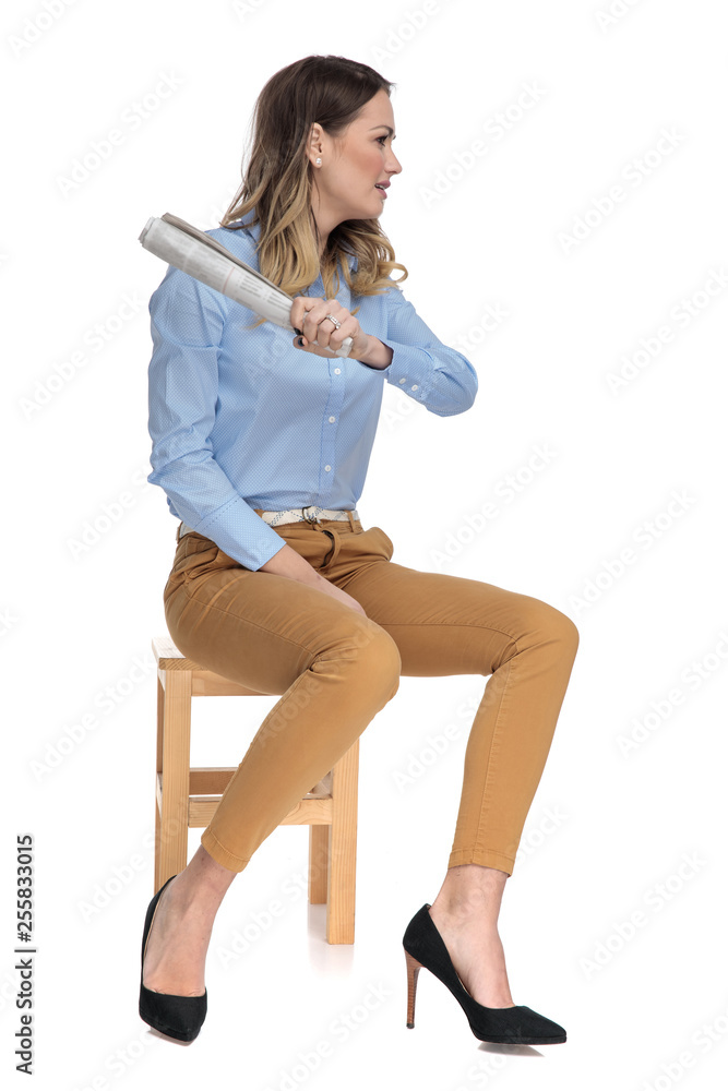 Sticker smart casual woman holding a rolled newspaper sits on wooden chair