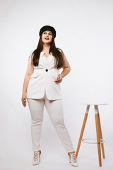 Plus size sexy model girl, fashionable brunette  with bright makeup and with stylish hairstyle, in...