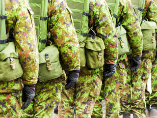 Fototapeta premium Army soldiers marching on the streets 