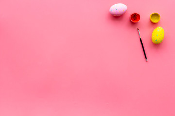 paint eggs for Easter celebration on pink background top view mock up