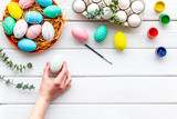 eggs with colorful paint for easter tradition on white wooden background top view mockup