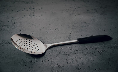 A spoon for drawing dumplings. The concept of preparing a meal, using kitchen accessories while cooking. Kitchen help.