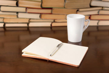 open notebook and cup  on the desktop