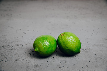 Lime on stone counter top. Resistance and health. Concept of eating, using fruits for dishes. Dish for a vegetarian. Healthy nutrition, eating vitamins. Citrus food, exotic fruits.
