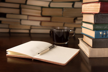 Naklejka premium open notebook and cup on the desktop