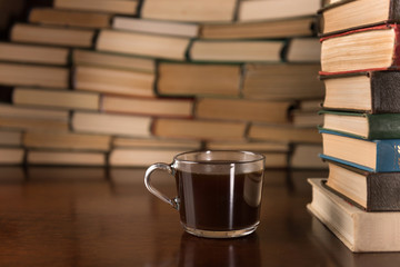 cup and many books on the desktop