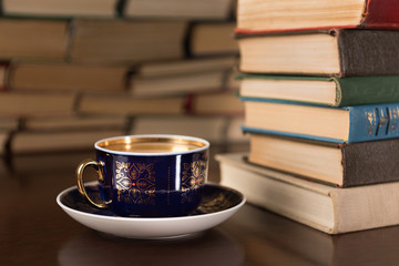 cup of tea on the background of books